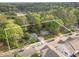 Aerial view of the property and surrounding neighborhood with mature trees and well maintained lawns at 412 Madison Ave, Cary, NC 27513