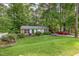 All brick home featuring a well-manicured lawn, mature landscaping and a spacious driveway at 412 Madison Ave, Cary, NC 27513