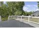 Spacious wood deck with white railings and view of fenced backyard and mature trees at 413 Redpath Dr, Garner, NC 27529