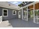 Large wood deck with white railings offering access to a screened porch and backyard at 413 Redpath Dr, Garner, NC 27529