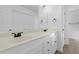 Bright bathroom featuring a double sink vanity, large mirror and white cabinets at 413 Redpath Dr, Garner, NC 27529