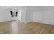 Bedroom with wood-look flooring, white walls, and a window with black curtains at 413 Redpath Dr, Garner, NC 27529