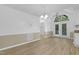 A bright dining room featuring laminate floors, a fan and exterior French doors at 413 Redpath Dr, Garner, NC 27529