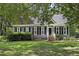Charming home featuring mature landscaping, a well-manicured lawn, and a welcoming entrance at 413 Redpath Dr, Garner, NC 27529