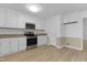 Spacious kitchen featuring stainless steel appliances, laminate floors, and ample white cabinetry at 413 Redpath Dr, Garner, NC 27529