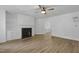 A spacious living room featuring a fireplace with built-ins and wood grain laminate floors at 413 Redpath Dr, Garner, NC 27529