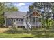 Exterior view of home featuring a screened porch, wood deck, and large yard with mature trees at 413 Redpath Dr, Garner, NC 27529