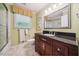 Bathroom with dark wood vanity, granite countertop, and walk-in shower at 415 Forsyth St, Raleigh, NC 27609