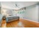 Comfortable bedroom featuring hardwood floors, neutral paint, and natural light from the window at 415 Forsyth St, Raleigh, NC 27609