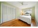 Cozy bedroom featuring hardwood floors, closet space, and a comfortable bed with decorative pillows at 415 Forsyth St, Raleigh, NC 27609
