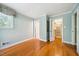 Neutral bedroom featuring hardwood floors, neutral paint, and multiple closets for extra storage space at 415 Forsyth St, Raleigh, NC 27609
