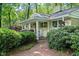 Home exterior featuring a brick walkway, white pillars, and mature landscaping at 415 Forsyth St, Raleigh, NC 27609