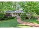 Charming home featuring a brick walkway, covered front porch, and lush landscaping at 415 Forsyth St, Raleigh, NC 27609