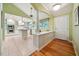 Bright open-concept kitchen featuring white cabinets, stainless appliances and hardwood floors at 415 Forsyth St, Raleigh, NC 27609