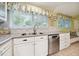 Kitchen featuring stainless steel appliances, tile backsplash, and granite countertops at 415 Forsyth St, Raleigh, NC 27609