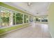 Bright sunroom featuring tile flooring, large windows, and ceiling fans, bringing the outdoors in at 415 Forsyth St, Raleigh, NC 27609