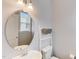 Neutral bathroom featuring an oval mirror, a pedestal sink, and white fixtures at 4613 Jersey Pine Dr, Rolesville, NC 27571