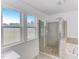 Bright bathroom features large glass shower, bathtub, and frosted privacy window at 4613 Jersey Pine Dr, Rolesville, NC 27571