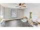 Bedroom with dark wood floors and a window overlooking the neighborhood at 4613 Jersey Pine Dr, Rolesville, NC 27571