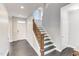 Inviting entryway featuring hardwood floors, a staircase with wood railing, and ample natural light at 4613 Jersey Pine Dr, Rolesville, NC 27571