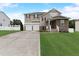 Charming two-story home featuring a two-car garage, stone accents, and a well-maintained front lawn at 4613 Jersey Pine Dr, Rolesville, NC 27571