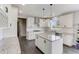 Modern kitchen with white cabinetry, granite countertops, a central island, and stainless steel appliances at 4613 Jersey Pine Dr, Rolesville, NC 27571