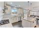 Well-lit kitchen featuring white cabinets, stainless steel appliances, granite countertops and breakfast bar at 4613 Jersey Pine Dr, Rolesville, NC 27571