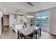 Bright and airy kitchen with white cabinetry, an island, stainless steel appliances, and access to the deck at 4613 Jersey Pine Dr, Rolesville, NC 27571