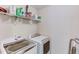 Laundry room features modern washer and dryer with overhead shelving for storage at 4613 Jersey Pine Dr, Rolesville, NC 27571