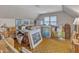 This attic has hardwood floors, a window, and is full of boxes and art at 4900 North Hills Dr, Raleigh, NC 27612