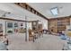 Finished basement featuring carpeted floors, wooden beams, and a brick fireplace at 4900 North Hills Dr, Raleigh, NC 27612