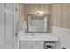 Bathroom featuring wallpaper, a large mirror, and a white sink at 4900 North Hills Dr, Raleigh, NC 27612