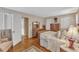 This bedroom features patterned wallpaper, hardwood floors, and a neutral color palette at 4900 North Hills Dr, Raleigh, NC 27612