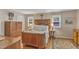 This bedroom features patterned wallpaper, hardwood floors, and antique furniture at 4900 North Hills Dr, Raleigh, NC 27612