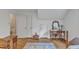 Bedroom featuring hardwood floors, a window, and antique furniture at 4900 North Hills Dr, Raleigh, NC 27612
