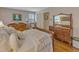 Comfortable bedroom featuring a wooden bed frame and patterned wallpaper at 4900 North Hills Dr, Raleigh, NC 27612