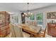 Comfortable dining room featuring a wooden table, elegant chairs, and ample natural light from the patio at 4900 North Hills Dr, Raleigh, NC 27612