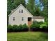 Charming two-story home with beige siding, brick accents, and a beautifully landscaped front yard with mature trees at 4900 North Hills Dr, Raleigh, NC 27612