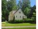 Charming two-story home with light siding, mature trees, and a well-manicured lawn at 4900 North Hills Dr, Raleigh, NC 27612