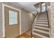Foyer with decorative wallpaper, wood floors, a decorative front door, and a staircase at 4900 North Hills Dr, Raleigh, NC 27612
