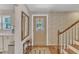 Foyer with a stained-glass front door, wooden floors, and staircase access to the upper level at 4900 North Hills Dr, Raleigh, NC 27612