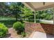 Inviting front porch with brick accents and a view of the landscaped front yard at 4900 North Hills Dr, Raleigh, NC 27612