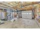 Spacious garage with concrete floors, a garage door, and lots of storage space at 4900 North Hills Dr, Raleigh, NC 27612