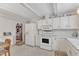 Traditional kitchen featuring white appliances and cabinetry at 4900 North Hills Dr, Raleigh, NC 27612