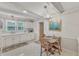 Charming kitchen with white cabinets, a chandelier and a breakfast table at 4900 North Hills Dr, Raleigh, NC 27612