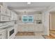Bright kitchen with white cabinetry, modern appliances, and a window above the sink at 4900 North Hills Dr, Raleigh, NC 27612