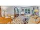 Comfortable living room featuring a light-filled space with access to the deck, hardwood floors, and elegant furnishings at 4900 North Hills Dr, Raleigh, NC 27612