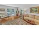 Cozy living room with hardwood floors, elegant furnishings, and French doors to the outdoors at 4900 North Hills Dr, Raleigh, NC 27612