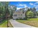 Exterior shot of the back of the house showing a driveway leading to a garage and an entrance at 4900 North Hills Dr, Raleigh, NC 27612