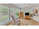 Bright sunroom with many windows and a comfortable sitting area at 4900 North Hills Dr, Raleigh, NC 27612